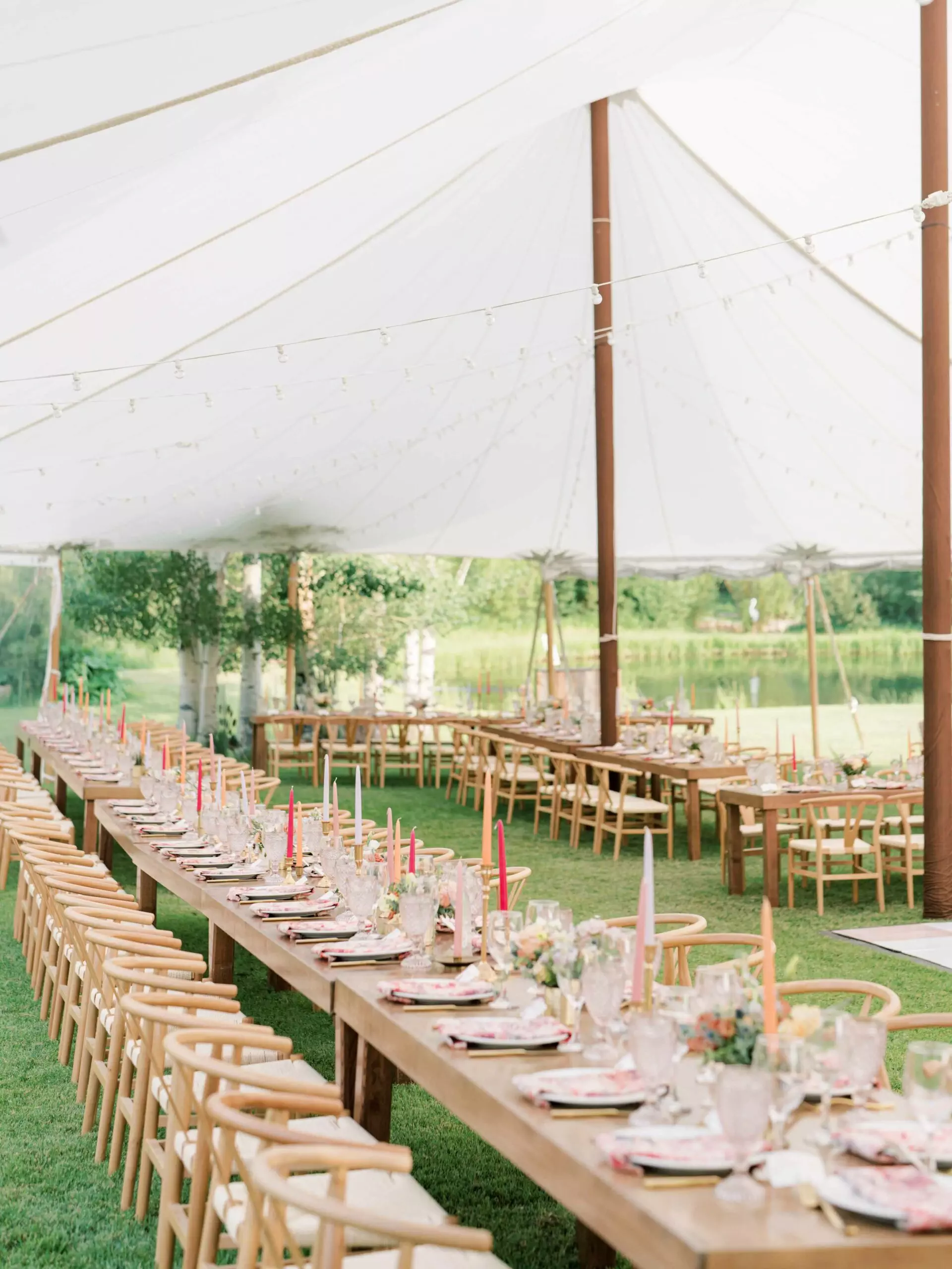 Wedding tent with wood farm tables